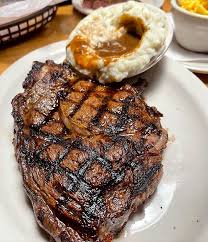 Texas Roadhouse signature dishes  Hand-Cut Steaks (e.g., USDA Choice Sirloin, Ribeye), Fall-Off-The-Bone Ribs, Fresh-Baked Bread with Honey Cinnamon Butter, Fried Pickles, Cactus Blossom.﻿﻿﻿﻿﻿﻿﻿﻿﻿